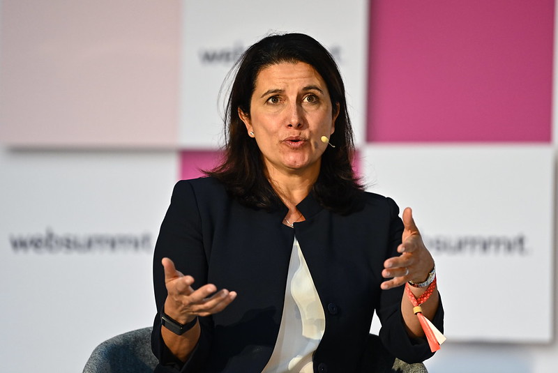 Photograph of a person (Beth Ferreira, managing director of FirstMark) speaking on Venture at Web Summit. Beth is wearing an on-ear microphone and sitting on a chair,