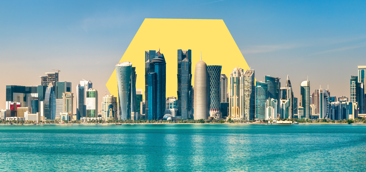 A photograph of the Doha city skyline. There is an illustration of a solid four-sided shape behind the skyline.