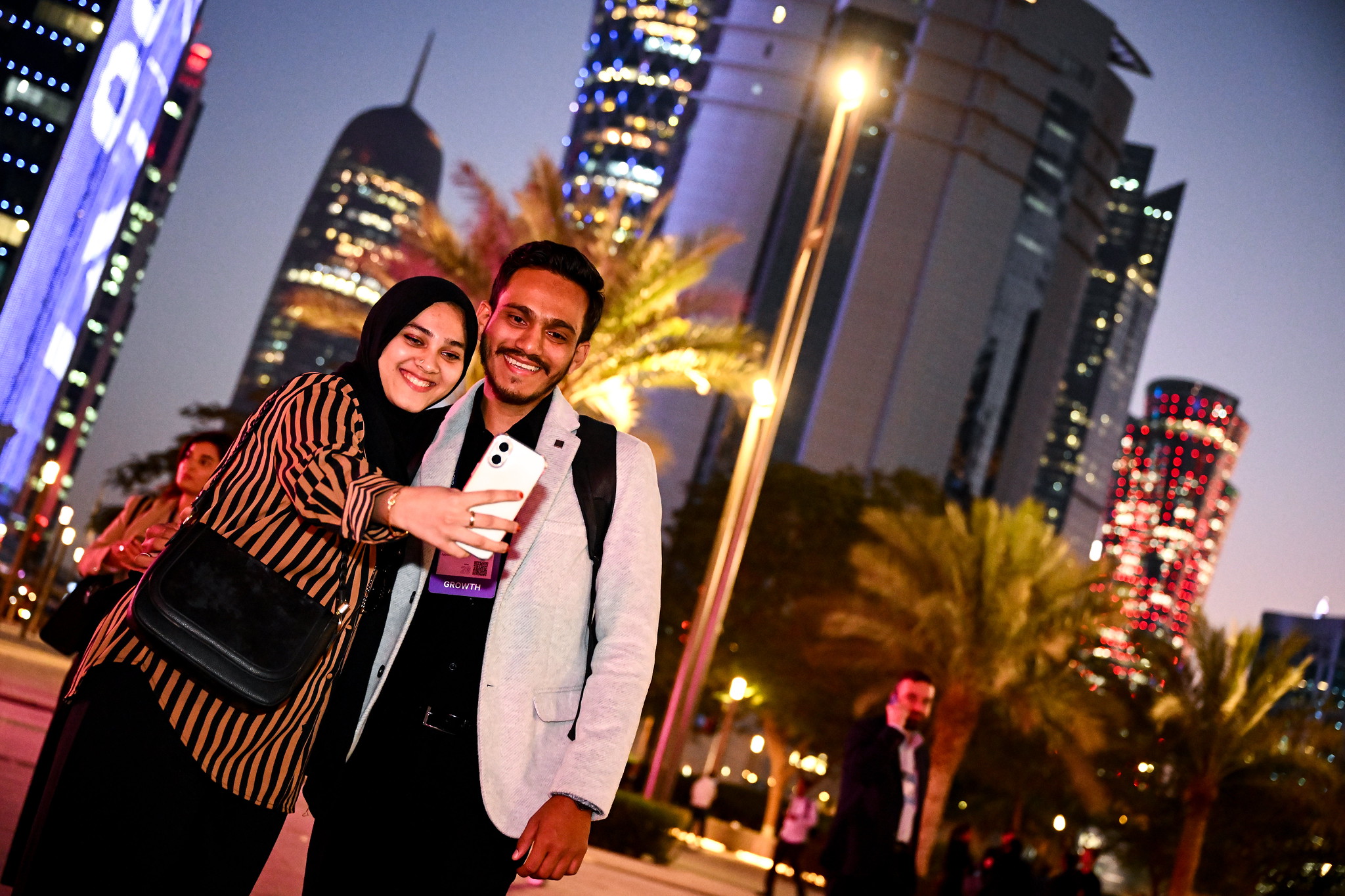 Attendees taking a selfie during day one of Web Summit Qatar 2026 at the Doha Exhibition and Convention Center in Doha