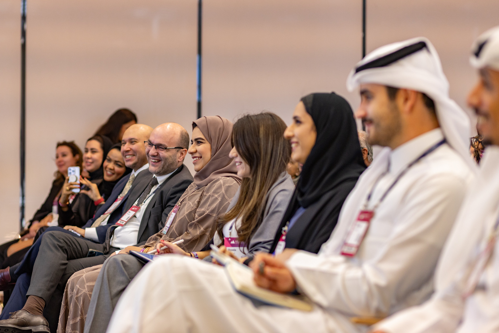 Attendees smiling during a highly-attended masterclass